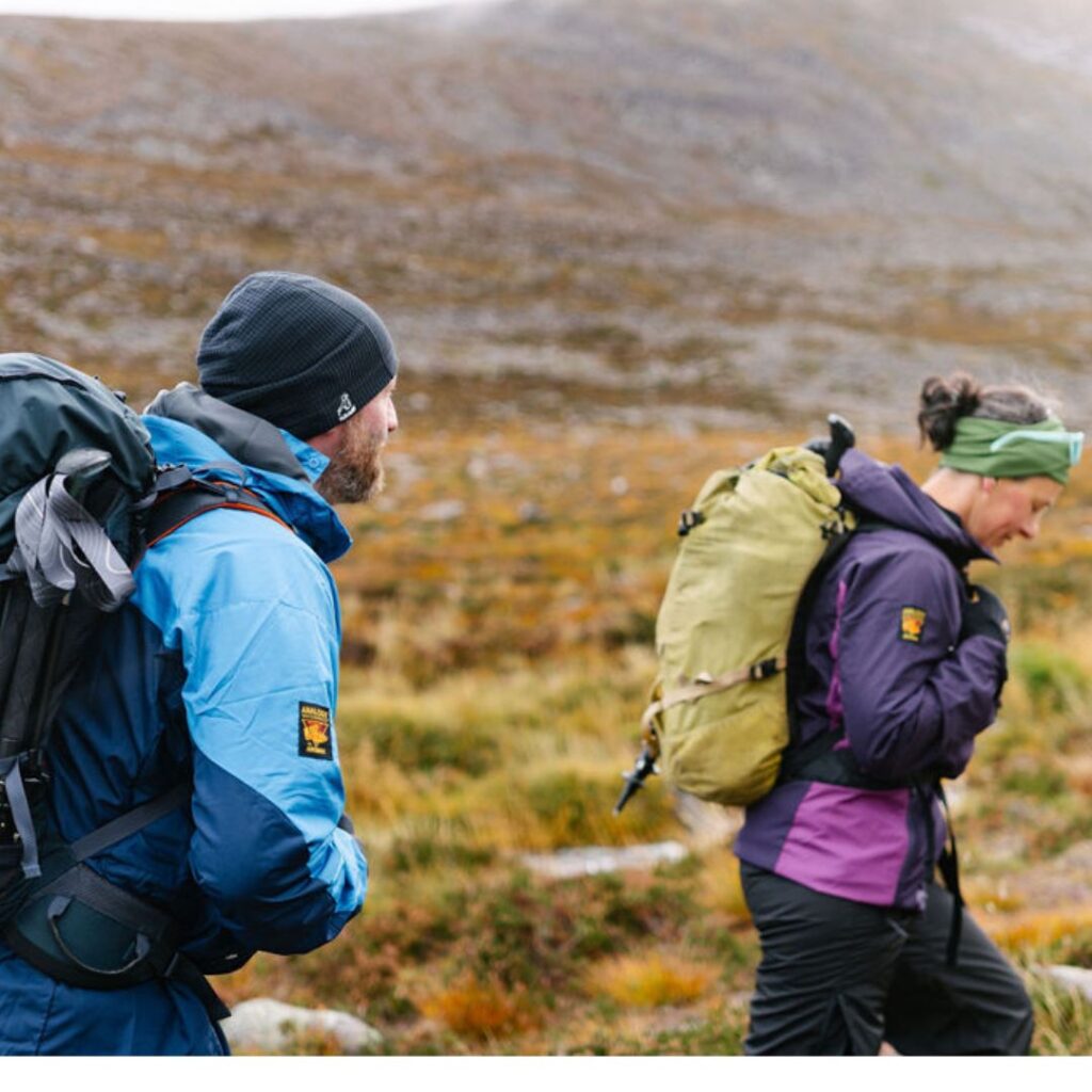 Male and female walker in lightweight jackets 