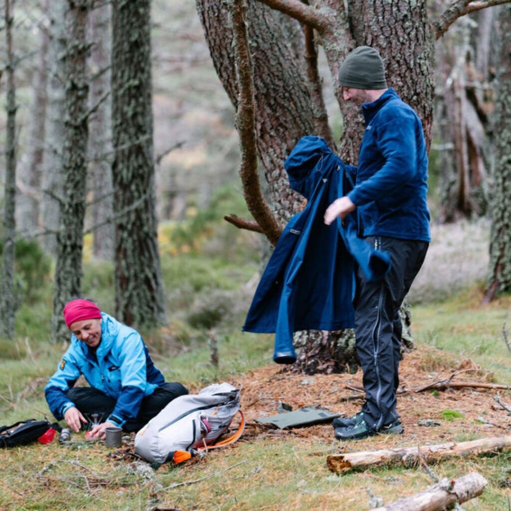 Male walker removing his lightweight jacket to reveal the layer of clothing beneath