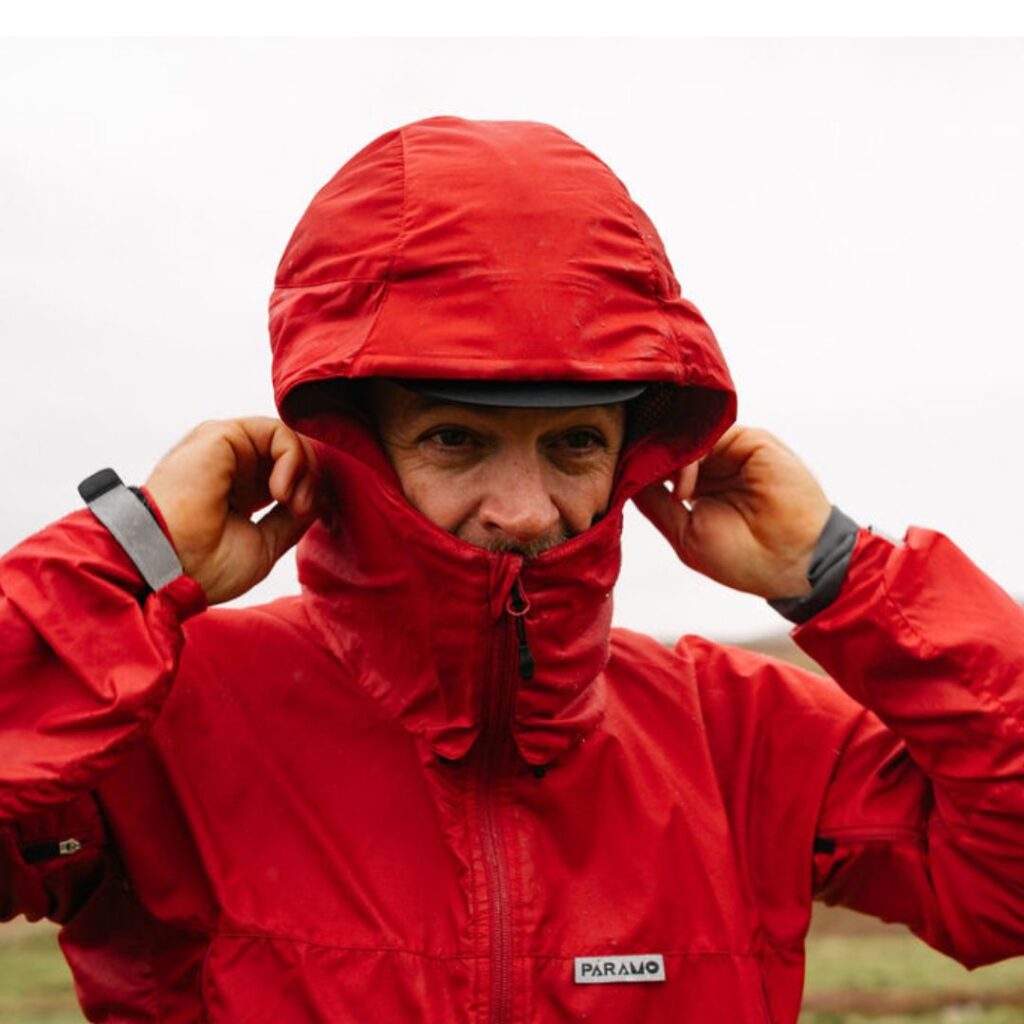 Man in Páramo waterproof jacket with hood up in the rain 