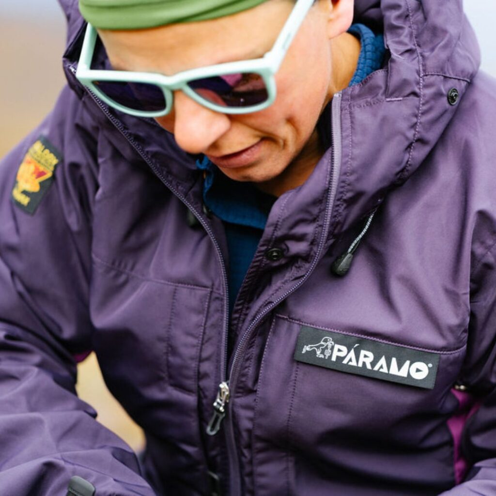 lady wearing mirrored sunglasses and a lightweight jacket looking at a map