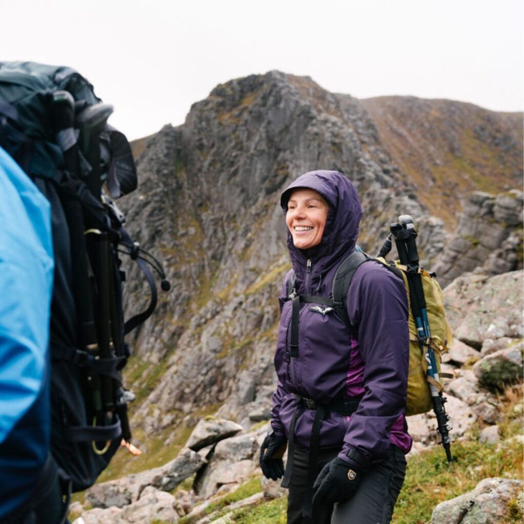 Couple walking in a mountain in waterproof jackers 